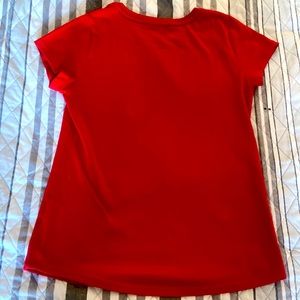 Red WONDERNATION shirt.